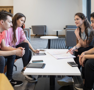 four students sat around table