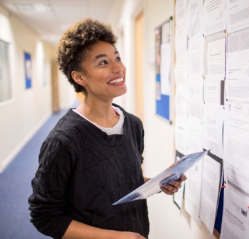 student looking at information board