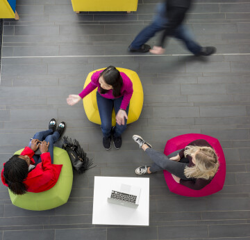 A bird's eye view looking down on three students seated in a triangle
