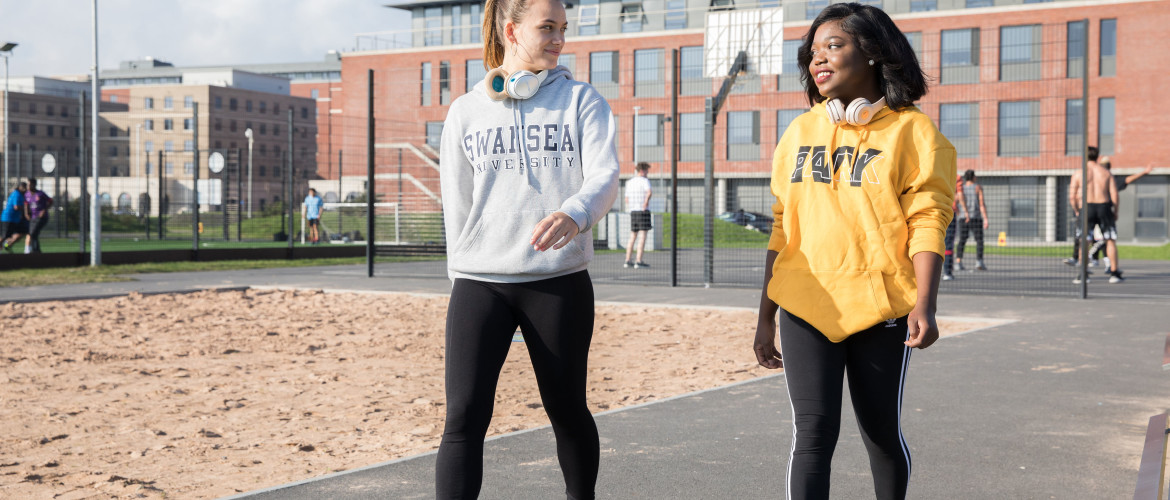 Two girls walking on campus