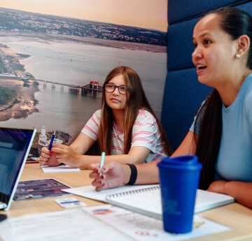Students talking in a booth in Digital Technium Building