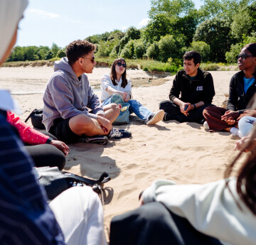 Students sitting on the beach