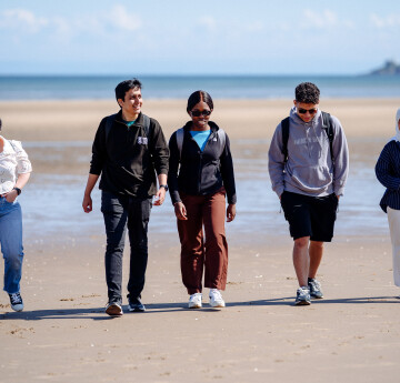 Students walking on Swansea Bay