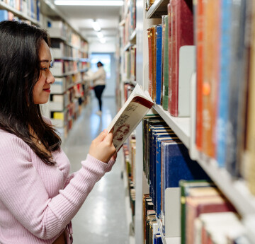 Lady looking at book in Library