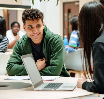 Students laughing in library