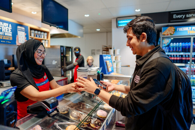 student purchasing food over a counter