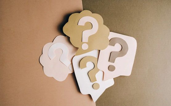 A set of question mark symbols made from cardboard